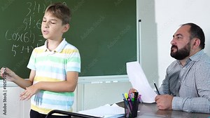 Male teacher and teenager boy on mathematics lesson