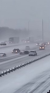 Sudden Whiteout Triggers Massive Highway Pileup ❄️ Interstate 271, Ohio — January 25, 2024 Fixed traffic-camera footage captures a sudden whiteout on Interstate 271 as heavy snow blasts across the roadway, reducing visibility to near zero. Headlights and taillights fade in and out of the storm when cars and semi-trucks hit black ice and instantly lose control. Vehicles slide sideways across lanes, spin through the median, and crash into barriers as the pileup rapidly grows. Hazard lights flash t