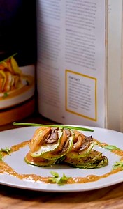 Here's a fancy veggie dish idea: confit byaldi! 🫑 Trish is once again upgrading her cooking arsenal and is taking a page off Binging with Babish's cookbook. 📕 We are big fans of making meals in our kitchen that look and feel like it was made in a restaurant. That's self care level 100. 😌 Try this at home today! | FEATR