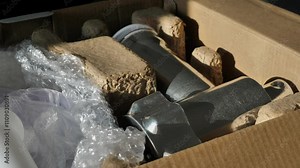 A person's hand takes a new household meat grinder out of the box, taking out the parts of the device to assemble the kitchen meat grinder. Unpacking a professional device for grinding meat into mince