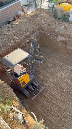 Pool leveling process with mini excavator