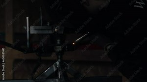 Witness the craft of welding in action in this stock footage clip, as a skilled welder uses their torch to expertly join metal pieces together in a bustling workshop creating sparks and a strong bond.