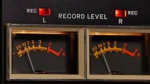 Vintage Reel to Reel tape recorder playing music close up of reel