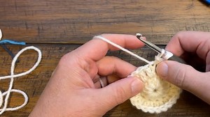 How to create a standing double crochet with the wrapping of loops around the hook. | The Crochet Crowd