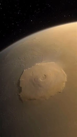ORMOUS 🌒 on Instagram: "Olympus Mons is massive. Located on Mars, it’s the biggest mountain in our entire solar system—a giant shield volcano formed by slow-flowing lava. ⠀⠀ Its slope is so gentle (just 5%!) that you could walk up it without even realizing you’re climbing a volcano. At the top? A 53-mile-wide crater made from six collapsed calderas stacked together. ⠀⠀ The cliffs around its base? They tower up to 6 miles high. ⠀⠀ To put it into perspective: Olympus Mons is nearly 100 times the 