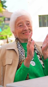 An elderly woman dancing in the garden of a nursing home or retirement home