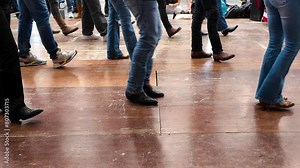 People dance with cowboy boots to typical American culture such as the Texan one. Group dances in company for fun. Quadrille conceptual Legs close up of tradition western folk