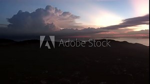 Drone cloud time lapse with large cumulus cloud - during sunset over Maenam village at Ko Samui island in Thailand