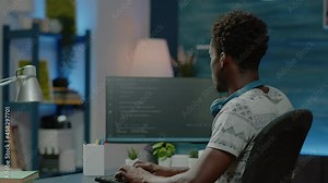 Person programming website firewall with codes on computer. Programmer coding web interface with binary code and network system for cybersecurity and protection. Coder designing server