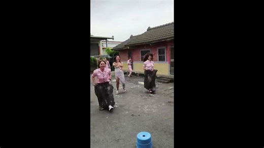 Bridesmaids play sack race game during bachelorette party