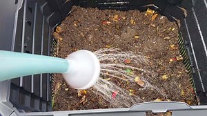 Download Watering compost for garden fertilization for free