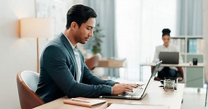 Man at desk, laptop and typing online in coworking space, market research and schedule at consulting agency. Office, admin and happy businessman at computer writing email review, feedback or report.