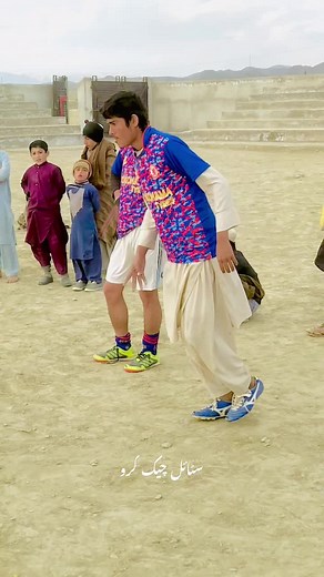 Children Enjoy Soccer Game in Sandy Outdoor Environment