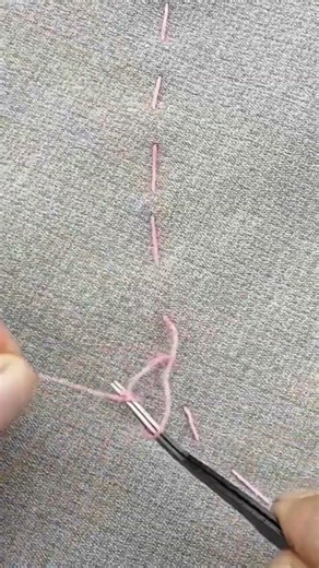 The process of sewing a fabric using a needle and thread by a tailor