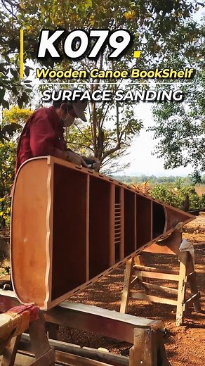A closer look at the surface sanding on the K079 - Wooden Canoe Bookshelf, showcasing the smooth finish and attention to detail in every curve #Woodworking #CanoeBookshelf #HandcraftedFurniture #InteriorDesign #Woodcraft #HomeDecor #FineSanding #OMHUSA | Wooden Boats