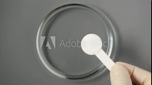 Sample of Dextrose monohydrate powder laid out with measuring spoon in Petri dish. D-Glucose or Grape sugar. Natural sweetener, sugar substitute. Stock Video