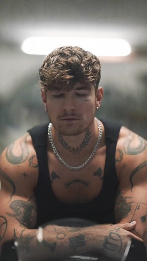 Muscular Individual Showcases Intricate Tattoo Designs