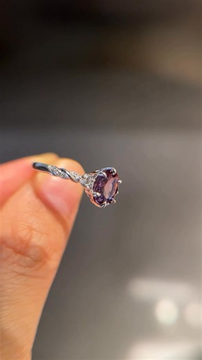 A love that intertwines, shines, and evolves.💚💙💜 Center alexandrite shifts colors as your love grows, while moissanite side stones sparkle like every shared moment. The crossed band represents your journey, woven together forever. #alexandrite #uniqueengagementrings #promisering #jewelry #proposal | Lovedenjewelry