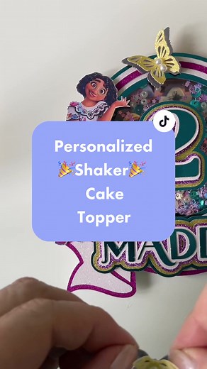 Make this personalized shaker cake topper with me!🎉🍰🎉 #caketoppertutorial #personalizedcaketopper #ugccreatorsoftiktok #shakercaketoppers #encantocaketopper #encantoparty #cricuttutorial #printthencut #shakertoppers #papercraftersoftiktok #glitterpaper #customcaketoppers
