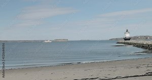 Spring point ledge light house at the end of a rock pier on the Atlantic Ocean.