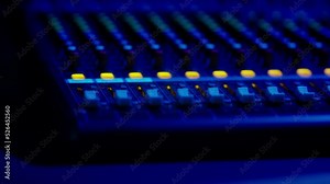 Mixing Console Faders in Use at a Professional Recording Studio