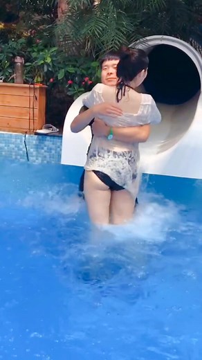 Adorable Baby Girl Having Fun on Water Slide at Waterpark