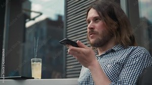 Man using the voice recognition on the phone, audio message ai speech helper, student male outdoor