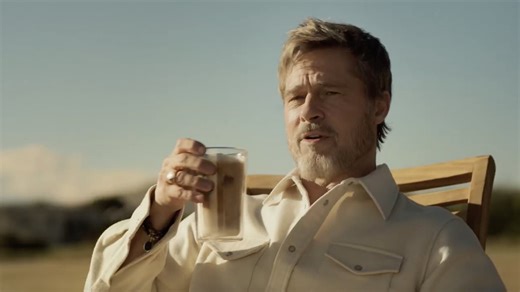 Brad Pitt sports scruffy beard and jewelry in new De'Longhi advert