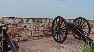 vintage cannon kept at top of the fort with bright sky from different angle