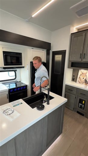 With a wrap around kitchen, and a sectional sofa with theater seats, the new Arctic Wolf 289PANO is perfect for hosting friends. #cherokeerv #neverstopgoing #forestriver #fifthwheel #arcticwolfrv #rvlife | Cherokee Travel Trailers & Fifth Wheels