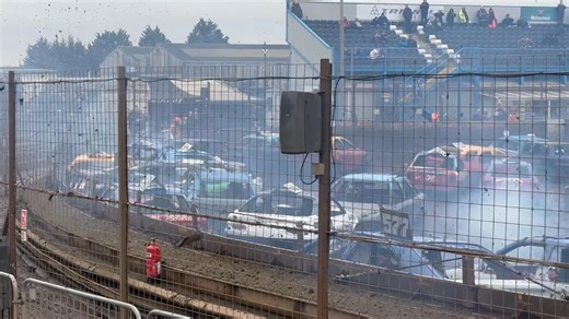 Early action in Heat 2 as several piled in on the scoreboard bend | Caged Bangers