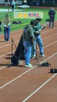 High school kids playing the national anthem on electric guitars