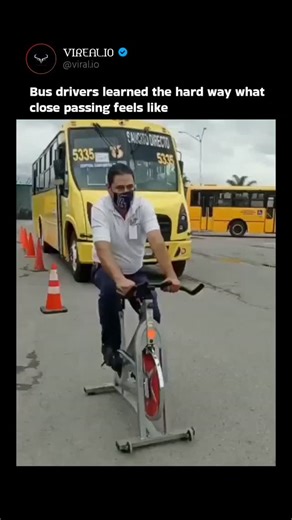 Anything Explaining on Instagram: "The video depicts a safety training session where bus drivers pedal stationary exercise bikes positioned inches from a moving yellow bus, simulating the intense wind shear experienced by cyclists during close passes. This hands-on demonstration aims to foster empathy among drivers, addressing a common cause of cycling accidents; studies from the UK's Department for Transport indicate that inadequate passing distances contribute to 20% of cyclist collisions. Thr