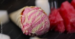watermelon and melon ice cream on the table, waffle cone with ice cream and pieces of melon and watermelon