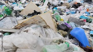 A big pile of garbage, a lot of plastic bags, garbage in the natural environment.