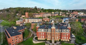 Woodburn Hall and West Virginia University downtown campus buildings. WVU college life establishing aerial shot.