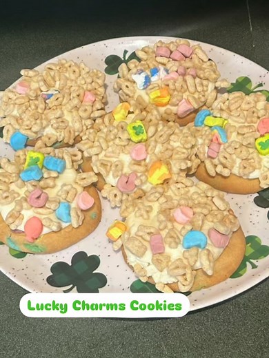 Lucky Charms Cookies Ingredients: 1 pack of lucky charms cookies 1 stick of soften butter 1 1/2 cup powdered sugar 2/3 cup marshmallow fluff 2 tablespoons heavy cream 1 cup lucky charms cereal Directions: 1. Preheat oven to 350 2. First add lucky charms cookies on a lined baking sheet 3. Bake at 350 for 15 minutes 4. While the cookies are baking make the marshmallow frosting 5. In a bowl add soften butter 6. Next add powdered sugar and marshmallow fluff 7. Mix until combined 8. Then add heavy cr
