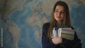 female high school student in the geography classroom. map blurred on background
