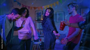 At the College House Party: Diverse Group of Friends Have Fun, Dancing and Socializing. Boys and Girls Dance in the Circle. Disco Neon Strobe Lights Illuminating Room.