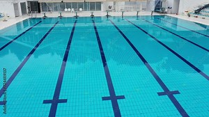 A Large Swimming Pool With a Blue Tiled Floor