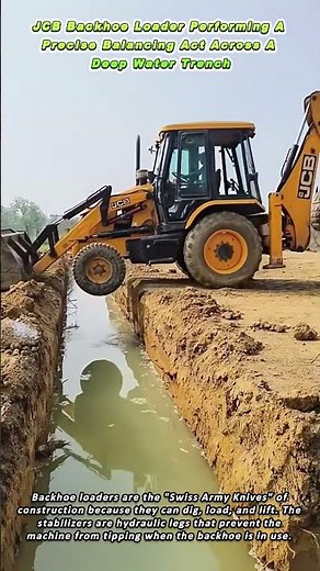 JCB Backhoe Loader Performing A Precise Balancing Act Across A Deep Water Trench