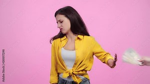 dissatisfied girl refusing money from woman then taking wedding ring from man and cheering Isolated On pink