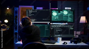 Dangerous hacker writing lines of code on PC from secret apartment, trying to get past security systems. Evil software developer building scripts that can hack devices, camera B