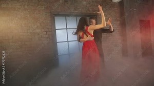 Professional dancers dancing tango in ballroom.