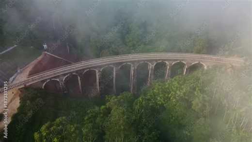 A view of the nine-arch bridge from above on a foggy early morning. Aerial photography in the fog of this historic and popular tourist destination in Sri Lanka. A legacy of the colonial era.