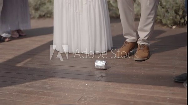 The groom's foot breaking a glass during a traditional jewish wedding ceremony. Symbolic moment representing remembrance and tje beginning of married life.