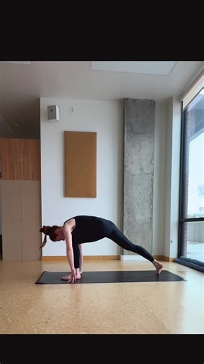 Bird of Paradise — From Warrior II, come into Extended Side Angle and stay for 3–5 breaths. Find your full bind — top arm wraps behind the spine, bottom arm threads underneath the front leg to meet the hand. Once the bind is secure, pause for a breath or two. Shift your weight into your front leg and step your back foot forward to the top of the mat. Root down through your standing leg, engage your core, and begin to lift the bound leg as you straighten the standing leg. Once upright, press thro