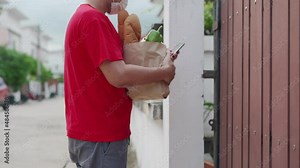 delivery man confirms checks the address and order through the application mobile. woman receive food online to eat at home. delivery man put a mask sent food for protect virus and safety.