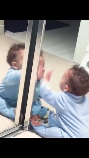 Cute baby kiss the mirror
