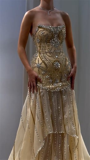 Reinee Couture| Luxury Custom Made Dresses on Instagram: "Share with a friend who would own the spotlight in this champagne corset gown! To order, send us a DM at @reineecouture. This champagne-toned gown is designed to captivate with its sculpted corset bodice, fully adorned with hand-applied crystals that shimmer with every movement. The strapless sweetheart neckline enhances the décolletage, while the structured corset cinches the waist beautifully before flowing into a soft, airy skirt. A cr